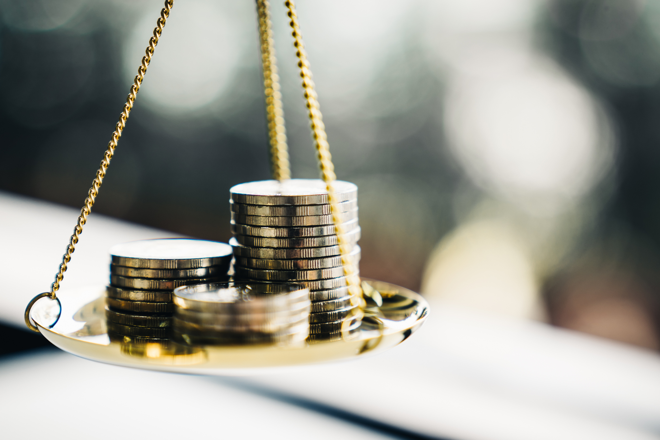 Money coins on a balancing scale