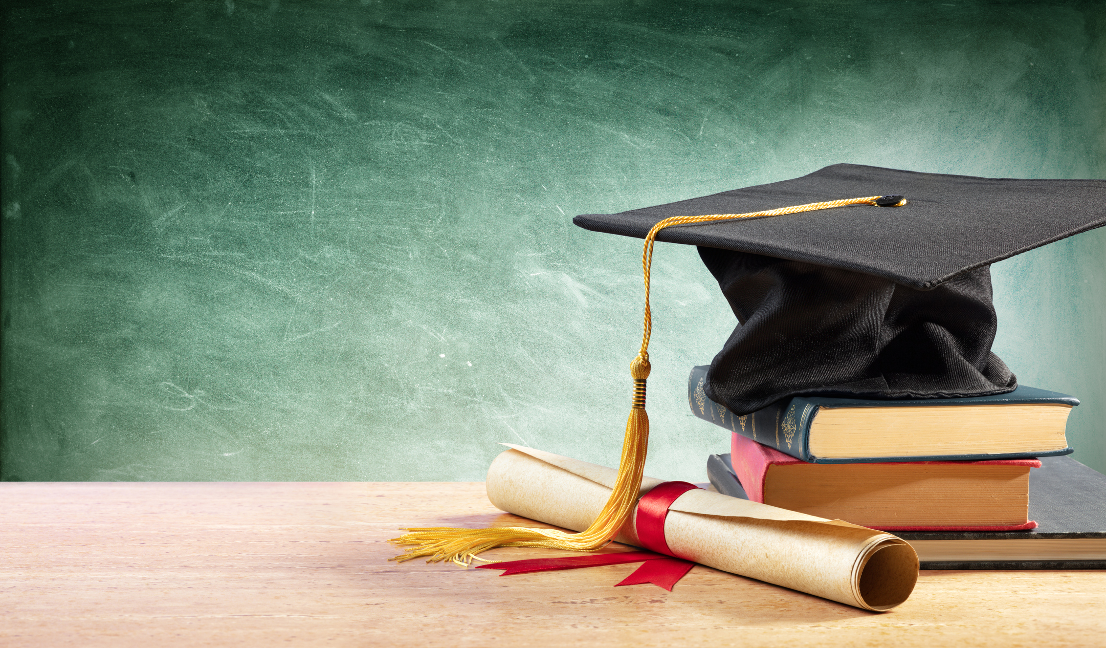 Degree Cap and books on a desk