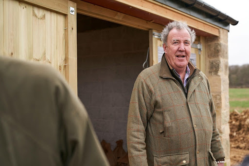 Jeremy Clarkson standing outside his diddly squat shop