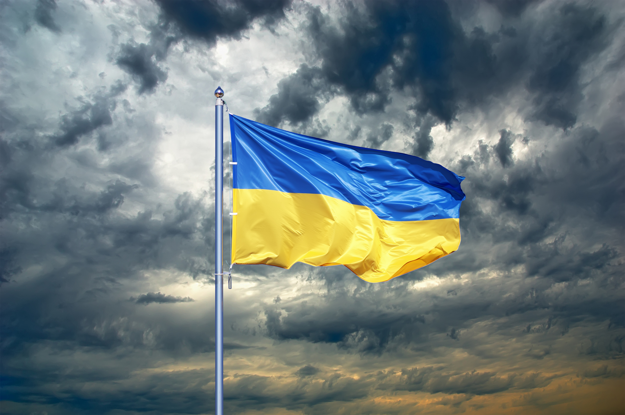 Ukraine Flag flying in dark clouds