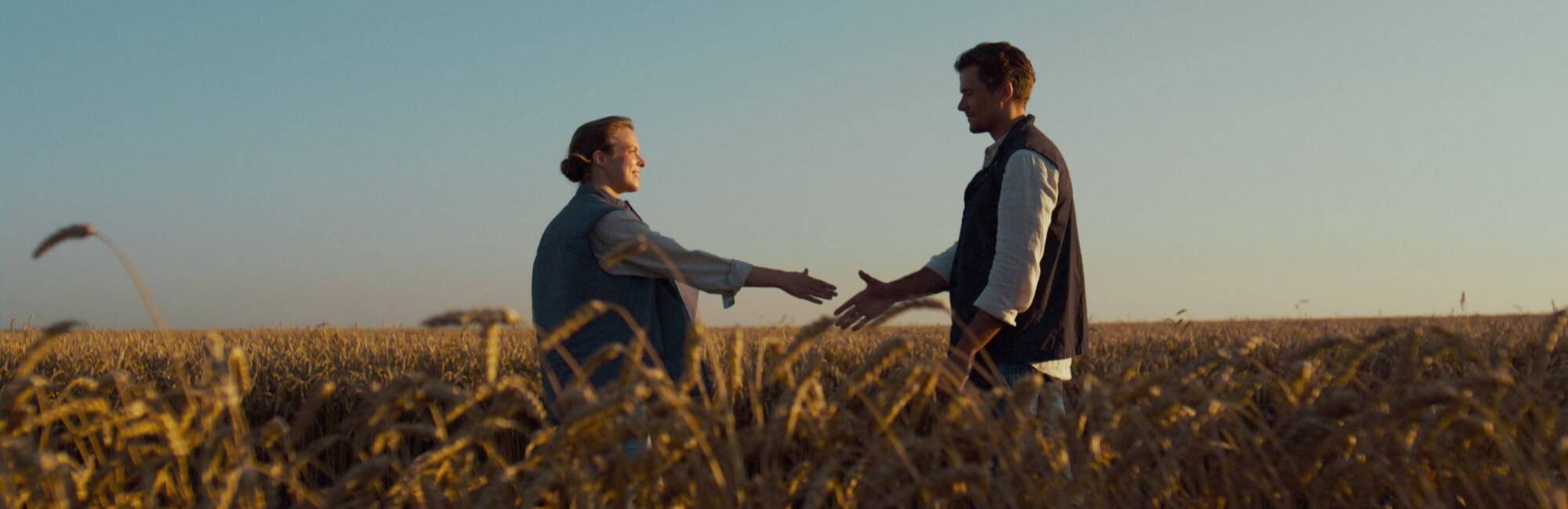 People Farmers shaking hands in a field 